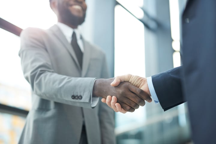 two business professionals shaking hands